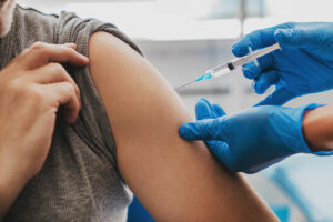 A person getting their arm examined by an adult.