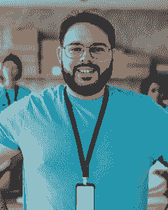A man with a beard and glasses is smiling