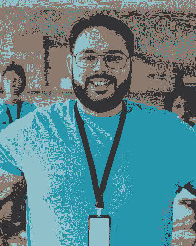 A man with a beard and glasses is smiling