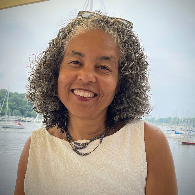 A woman with grey hair smiling for the camera.