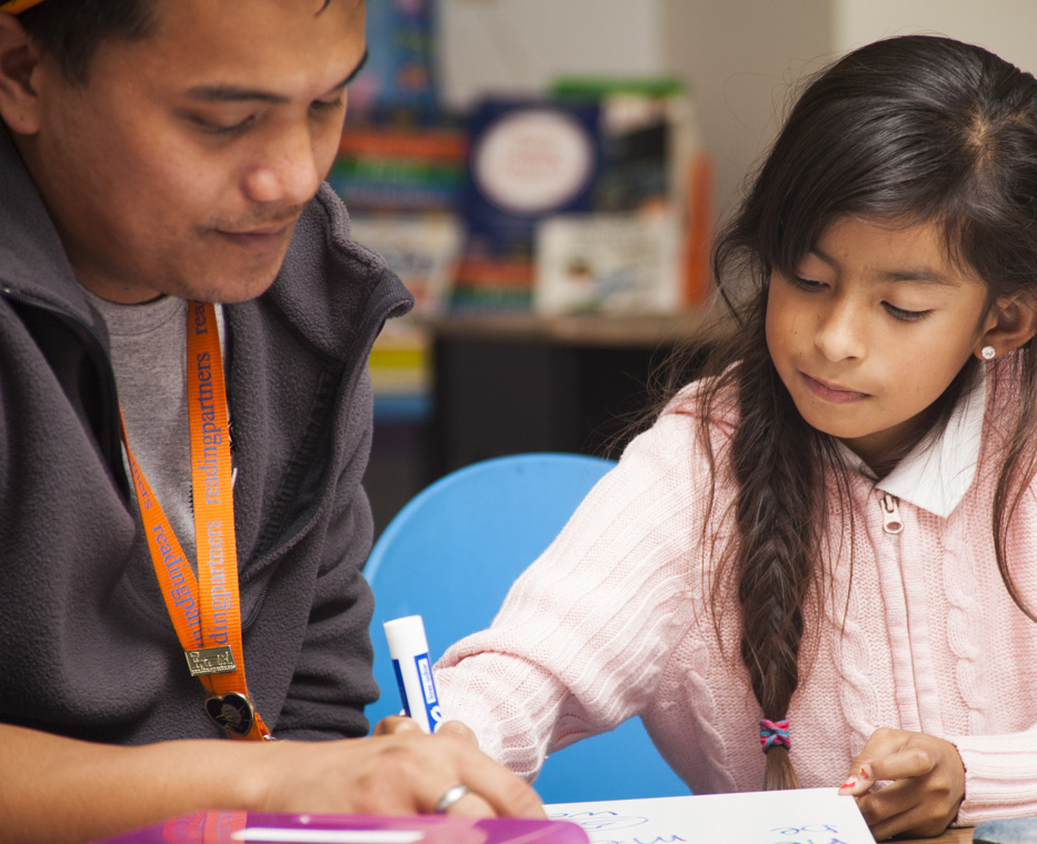 A man and girl are working on homework.