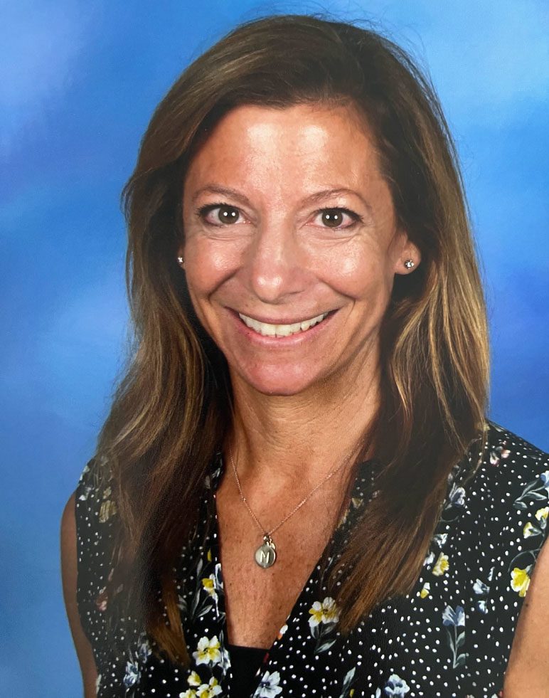 A woman with long hair and a smile.